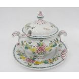 A PORTUGESE EARTHENWARE SOUP TUREEN, COVER, LADLE AND STAND, BOLDLY PAINTED WITH FLOWERS AND