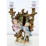 A CONTA & BOEHME FLORAL ENCRUSTED PORCELAIN CANDELABRUM IN THE FORM OF TWO TREE TRUNKS WITH THE