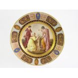 A VIENNA STYLE PLATE, PAINTED WITH THREE CLASSICAL FIGURES AT AN ALTAR IN RAISED GILT PANELLED