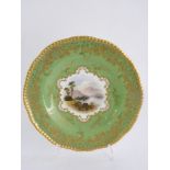 A COALPORT APPLE GREEN GROUND DESERT PLATE, PAINTED BY E. O. BALL, SIGNED, WITH KILCHURN CASTLE IN
