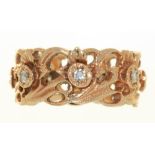 A DIAMOND ETERNITY RING BY STUART DEVLIN, WITH A REPEATING PATTERN OF DAFFODILS, IN 14CT GOLD, 6G,