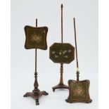 A PAIR OF VICTORIAN CARVED MAHOGANY POLE SCREENS WITH WOOLWORK BANNERS AND ANOTHER, SIMILAR, FAULTS