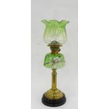 A VICTORIAN BRASS REEDED COLUMNAR OIL LAMP, THE SHADED GREEN GLASS FOUNT ENAMELLED WITH A LILY,