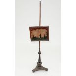 A REGENCY MAHOGANY POLE SCREEN, THE GLASS BANNER PAINTED WITH SILHOUETTES OF A FAMILY