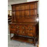 AN OAK DRESSER AND RACK ON SPIRAL TURNED LEGS, WITH PANELLED DOORS, C1930'S, 188CM H; 138 X 53CM