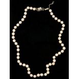 A SINGLE ROW OF 6 MM CULTURED PEARLS, WITH DIAMOND CLASP IN WHITE GOLD MARKED 14K, 47 CM L++LIGHT