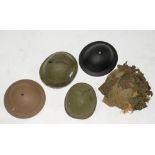 MILITARIA. A U.S. WWII INFANTRY HELMET, A BRITISH ARMY INFANTRY HELMET AND THREE OTHERS