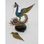 A SOUTH EAST ASIAN GILT SILVER COLOURED FILIGREE METAL AND TRANSLUCENT ENAMEL MODEL OF A PEACOCK,