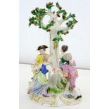 A MEISSEN GROUP OF FOUR BOYS AND GIRLS DANCING AROUND A FRUITING TREE ON SCROLLING GILT BASE, 29CM