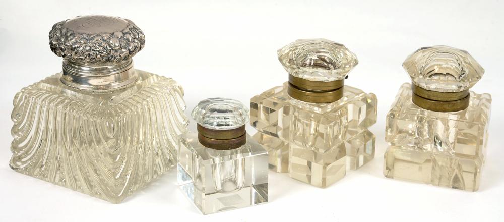 A SILVER MOUNTED GLASS INKWELL, 11 CM H, MARKED STERLING NEW YORK, AND THREE BRASS MOUNTED GLASS