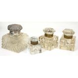 A SILVER MOUNTED GLASS INKWELL, 11 CM H, MARKED STERLING NEW YORK, AND THREE BRASS MOUNTED GLASS