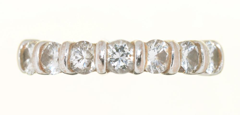 A DIAMOND RING, THE SEVEN SEMI FLUSH SET BRILLIANT CUT DIAMONDS 0.85CT APPROX, J COLOUR, VS2/SI1