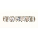 A DIAMOND RING, THE SEVEN SEMI FLUSH SET BRILLIANT CUT DIAMONDS 0.85CT APPROX, J COLOUR, VS2/SI1