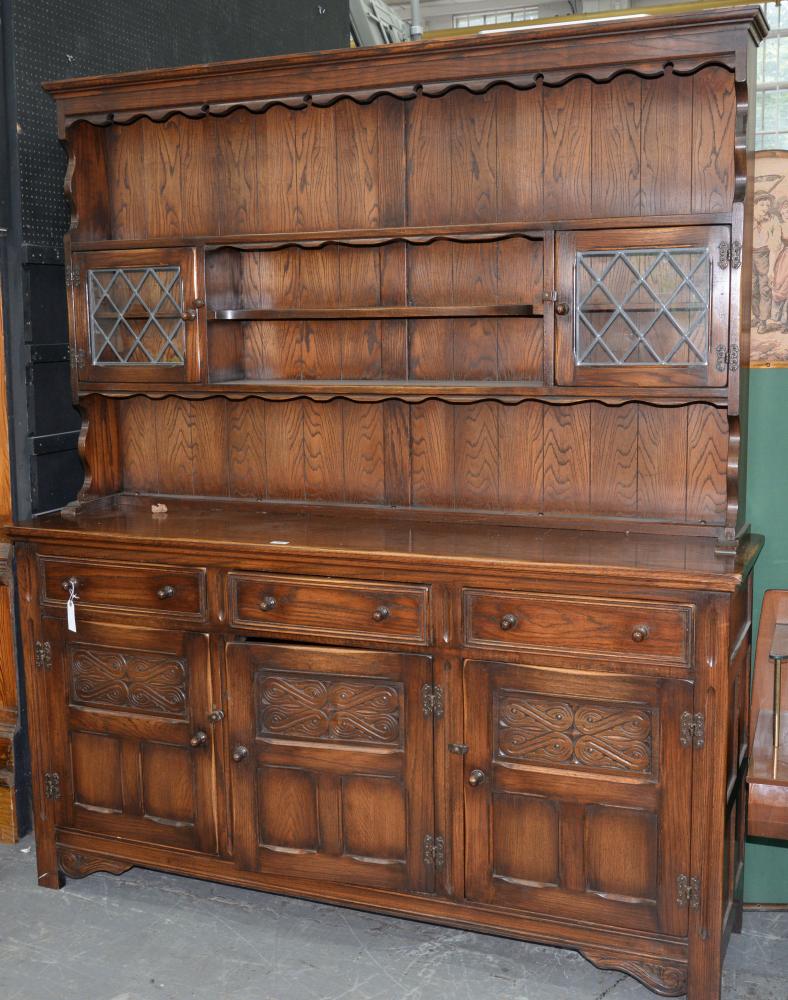 AN ANTIQUE STYLE CARVED AND PANELLED OAK DRESSER AND RACK, 196CM H X 170CM W