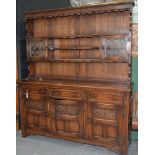 AN ANTIQUE STYLE CARVED AND PANELLED OAK DRESSER AND RACK, 196CM H X 170CM W