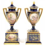 A PAIR OF VIENNA STYLE COBALT GROUND SHIELD SHAPED PEDESTAL VASES AND COVERS, PAINTED WITH OVAL
