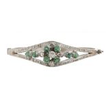 AN EMERALD AND DIAMOND BANGLE, the brilliant cut diamonds approx 0.6 ct, the emeralds approx 0.7 ct,