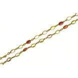 A GEM SET GOLD CHAIN, WITH GARNET, AMETHYST , PERIDOT, TOPAZ AND CITRINE SPECTACLE SET, 58 CM L