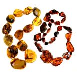 A NECKLACE OF AMBER NUGGET BEADS, 60 CM L APPROX, 196G, AND A NECKLACE OF CHERRY AMBER BEADS, 78