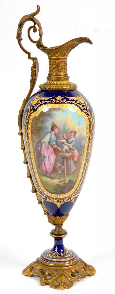A SEVRES STYLE GILTMETAL MOUNTED COBALT GROUND PORCELAIN EWER, PAINTED WITH A SHEPHERDESS AND
