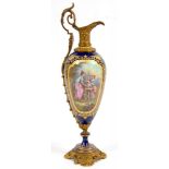 A SEVRES STYLE GILTMETAL MOUNTED COBALT GROUND PORCELAIN EWER, PAINTED WITH A SHEPHERDESS AND