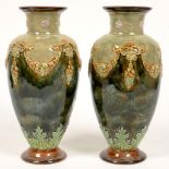 A PAIR OF DOULTON WARE SHOULDERED OVIFORM VASES WITH FLARED NECK, DECORATED IN RELIEF WITH FESTOONS,