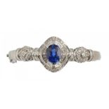 A SAPPHIRE AND DIAMOND BANGLE, the baguette and brilliant cut diamonds approx 1.5 ct, the oval