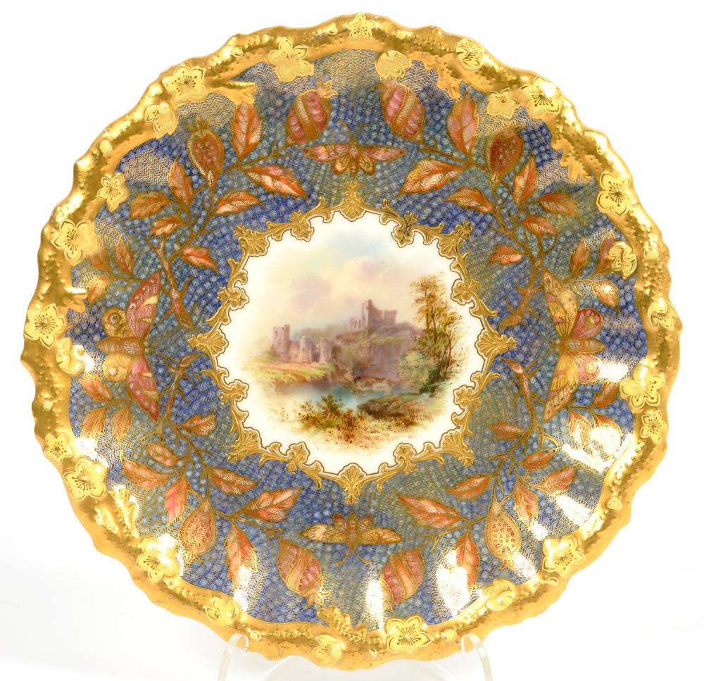 A COALPORT MOULDED DESSERT PLATE, PAINTED TO THE CENTRE WITH A CASTLE IN RAISED GILT SURROUND AND