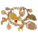 A 9CT GOLD CHARM BRACELET with a collection of charms including a half sovereign and a Victorian