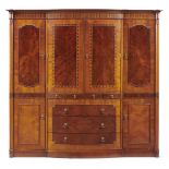 A BOW CENTRED MAHOGANY AND INLAID WARDROBE MAPLE & CO LONDON, C1910 with plum pudding figured