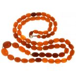 A NECKLACE OF SEVENTY TWO AMBER BEADS 87g++Superficial crazing and wear, in need of restringing