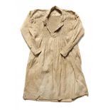 RURAL BYGONES. A BEIGE LINEN TWILL WORKING SMOCK, MID 19TH C of coat-type with smocked panel front