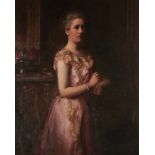 JOSEPH HERBERT BENTLEY, RBA (1866-1934) PORTRAIT OF A LADY three quarter length in a pink dress in