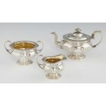 A SCOTTISH GEORGE III SILVER TEA SERVICE spirally reeded with foliate chased rim, teapot 17cm h,