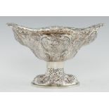 A VICTORIAN PIERCED AND EMBOSSED SILVER FRUIT BOWL on oval foot, 19.5cm h, by Charles Stuart Harris,