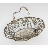 A GEORGE III SILVER BREAD BASKET the openwork swing handle applied with ears of wheat, the