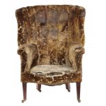 A GEORGE III MAHOGANY ARMCHAIR with curved back and outscrolled arms, on square tapering legs++