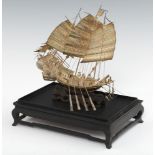 A CHINESE EXPORT SILVER MODEL OF A WAR JUNK, C LATE 19TH C on wave carved wood stand, 24cm h, marked