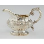 A WILLIAM IV SILVER CREAM JUG of melon form and chased with scallop shells, 11cm h, by John, Henry &