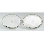 A PAIR OF GEORGE III OVAL SILVER WAITERS moulded cavetto and gadrooned rim, on four conforming feet,