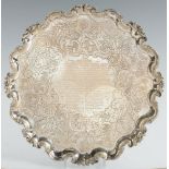 PARLIAMENTARY INTEREST. AN IRISH GEORGE II SILVER SALVER on four feet, later chased, 41.5cm diam, by