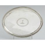 A GEORGE III OVAL SILVER SALVER on four reeded feet, crested, 23cm l, by George Smith II and