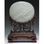 A CHINESE WHITE JADE PLAQUE, QING DYNASTY, 19TH C of slightly convex form carved with phoenix and