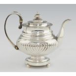 A GEORGE IV SILVER TEAPOT spirally reeded, crested, 21cm h, by John Edward Terrey, London 1821,