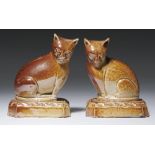 A PAIR OF ENGLISH SALTGLAZED BROWN STONEWARE MODELS OF CATS, C1820 8cm h++One with minor chips under