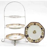 AN EPNS THREE TIER CAKE STAND AND SET OF THREE NORITAKE OCTAGONAL COBALT AND RAISED GILT PLATES,