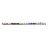 AN EDWARDIAN CALIBRE SAPPHIRE AND SINGLE CUT DIAMOND BAR BROOCH IN GOLD WITH WHITE ENAMEL