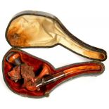 A CARVED MEERSCHAUM CHEROOT HOLDER IN THE FORM OF THE HEAD OF A SPANIEL AND HUNTING HORN, AMBER