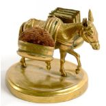 NEEDLEWORK TOOLS. AN UNUSUAL EMBOSSED BRASS SEWING COMPANION IN THE FORM OF A DONKEY, ONE OF ITS