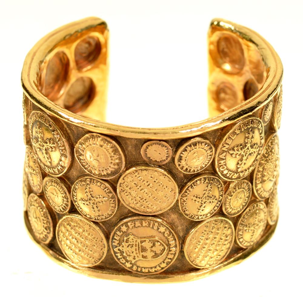 A CHANEL BRASS COIN CUFF BRACELET, INSCRIBED INSIDE CHANEL, 28, MADE IN FRANCE++IN GOOD CONDITION